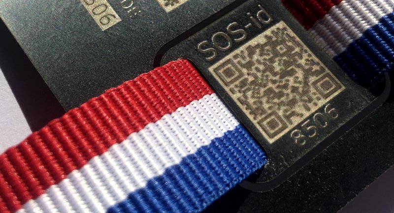 SOS-ID tag detail — engraved QR code with wristband